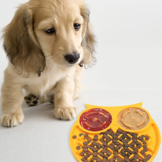 Dog staring at the yellow owl sticky mat with food